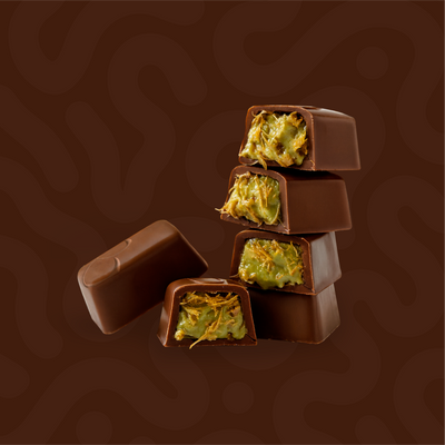 Stack of milk chocolate bites with crunchy pistachio kunafa filling