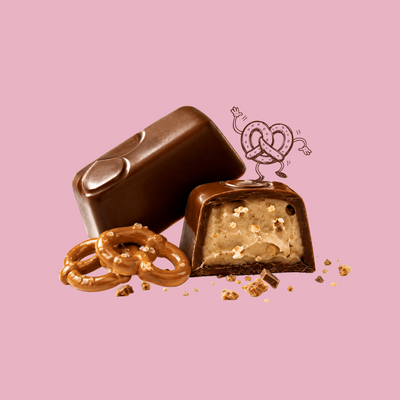 Milk chocolate pretzel bite cut open to show the pretzel cream filling
